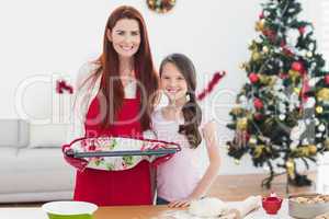 Festive mother and daughter baking together