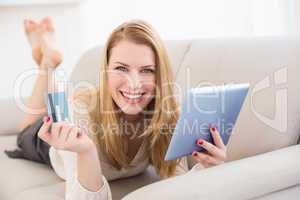 Woman doing online shopping with tablet and credit card