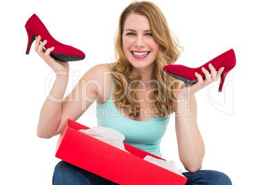 Smiling woman holding up her new shoes