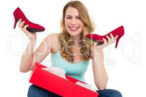 Smiling woman holding up her new shoes