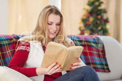 Pretty blonde reading book at christmas time