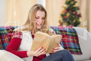 Pretty blonde reading book at christmas time