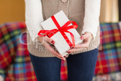 Woman with nail varnish holding gift