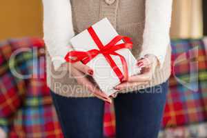 Woman with nail varnish holding gift