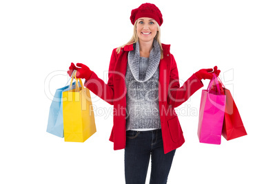 Blonde in winter clothes holding shopping bags