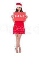 Brunette in red dress holding sale sign