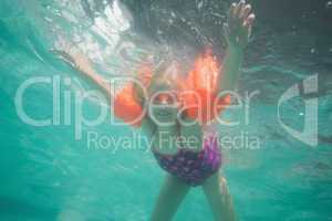 Cute kid posing underwater in pool