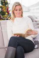Relaxed blonde reading on the couch at christmas