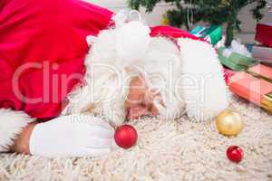 Exhausted santa resting on the rug