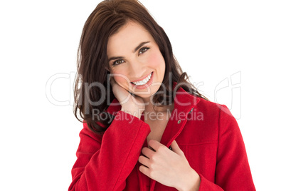 Portrait of a smiling brunette in red coat