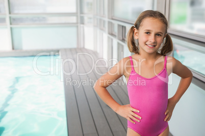 Cute little girl standing poolside