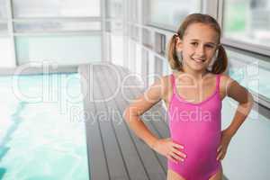 Cute little girl standing poolside