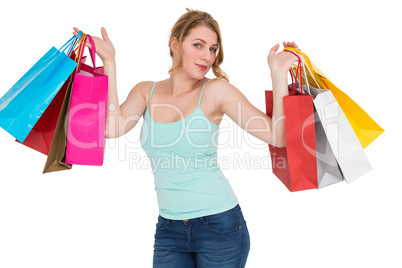 Cheerful woman holding shopping bags