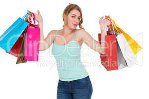 Cheerful woman holding shopping bags