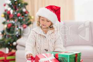 Cute little girl surrounded by christmas gifts