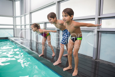 Cute swimming class about to jump in pool