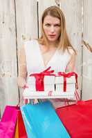 Serious blonde with shopping bags and gifts