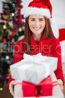 Festive redhead holding christmas gifts