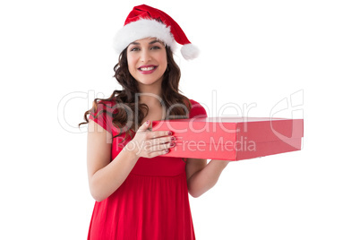 Brunette in santa hat holding box