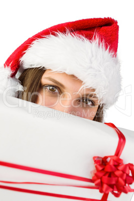 Festive brunette showing a gift