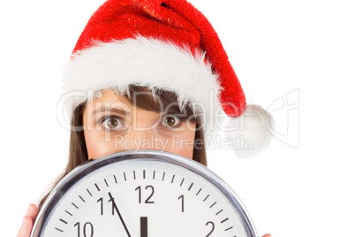 Portrait of a festive brunette holding a clock