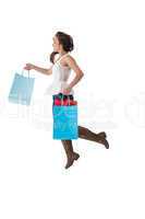 Happy brunette leaping with shopping bags