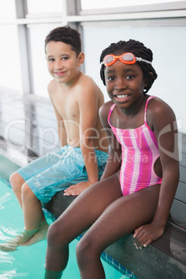 Cute little kids sitting poolside