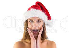 Surprised brunette in santa outfit