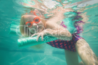 Cute kid posing underwater in pool