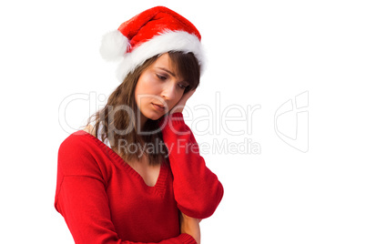 Sad woman in santa hat holding her head