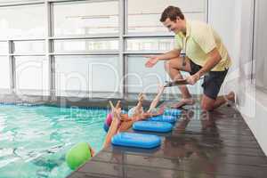 Cute swimming class listening to coach