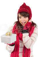 Surprised young woman holding a wrapped gift