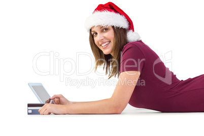 Festive brunette shopping online with tablet