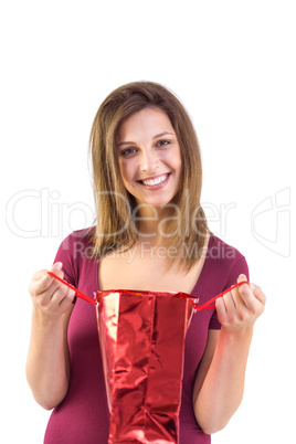 Festive brunette opening a gift bag