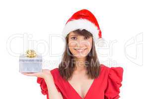 Festive brunette holding a gift