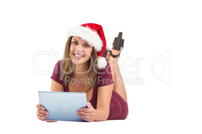 Festive brunette using tablet pc