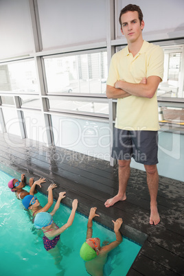 Cute swimming class watching the coach