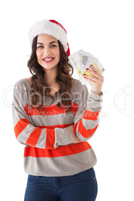 Festive brunette holding her cash