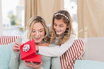 Mother opening christmas gift with daughter