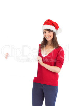 Festive brunette holding a poster