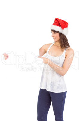 Pretty girl in santa hat holding poster