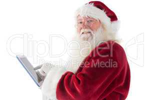 Santa uses a tablet PC and smiles into the camera