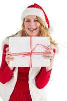 Pretty blonde in warm clothing holding a gift