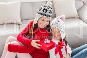 Mother and daughter exchanging gifts at christmas