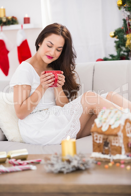Relaxed brunette holding a mug of hot drink
