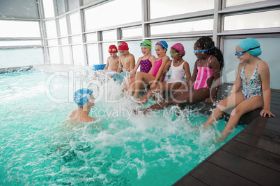 Cute swimming class in pool with coach