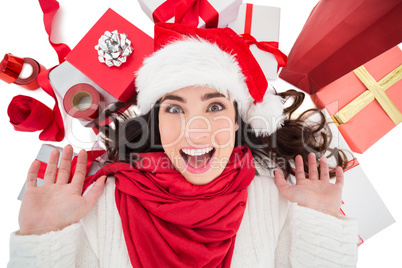 Excited brunette lying near christmas presents