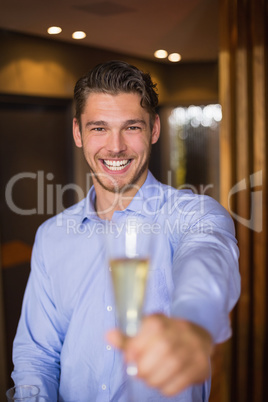 Handsome man holding flute of champagne