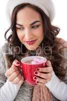 Brunette having hot chocolate with marshmallow