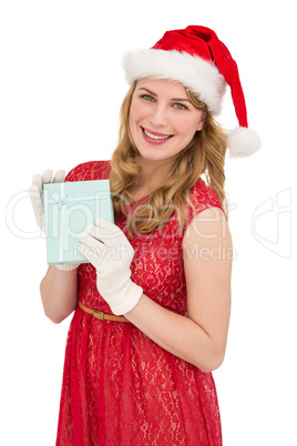 Smiling blonde in red dress wearing gloves and santa hat